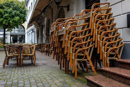 Stacked Wicker Caf&eacute; Chairs Outside an Empty Urban Restaurant