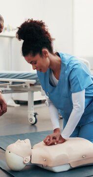 Doctor, dummy and woman at hospital for cpr, demonstration and medical course for critical care. People supervision and nurse in clinic with mannequin, training assessment and emergency resuscitation