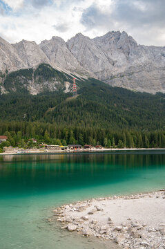 Scenic vertical view of Eibsee lake with turquoise water and Zugspitze mountain in Bavaria, Germany