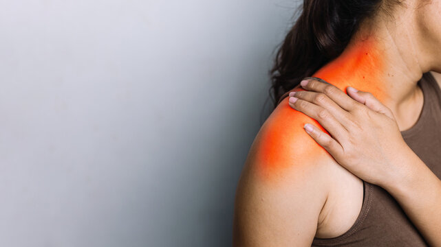 Woman with Shoulder Pain and Inflammation, Holding Her Shoulder with Red Highlighted Area for Joint Injury and Healthcare Concept