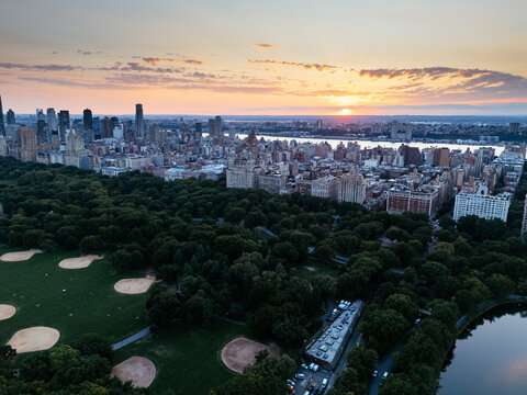 Aerial view of Central Park surrounded by Manhattan skyscrapers and New York City skyline.