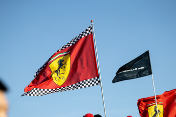 Fototapeta premium 24 May 2026, Montreal, Canada: Ferrari flags wave above Formula 1 fans at Grand Prix weekend. g.