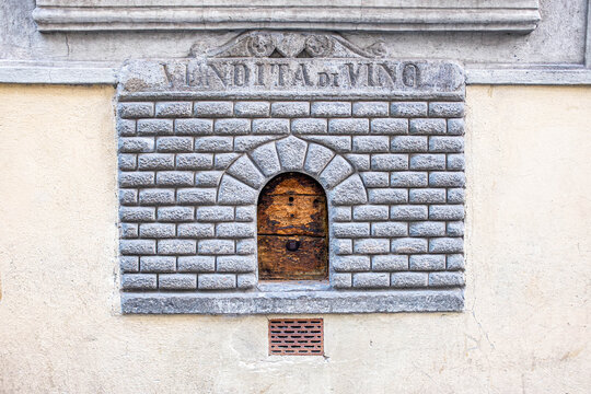 Ancient Wine Window, with "Vendita di vino" written "Wine Sale". Detailing and Inscription on Historic Palace Wall Architecture in Florence, Italy.