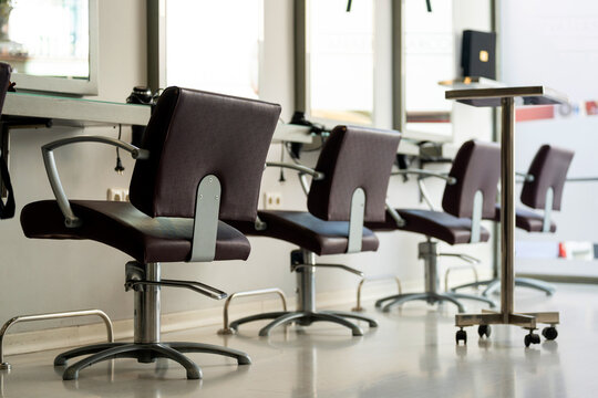 Hair salon interior showing empty styling chairs ready for clients and services