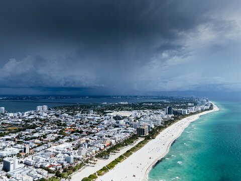 Aerial view of Miami Beach, Florida, with turquoise ocean, white sandy beach, waterfront buildings and coastline