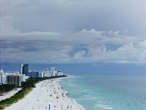 Aerial view of Miami Beach, Florida, with turquoise ocean, white sandy beach, waterfront buildings and coastline