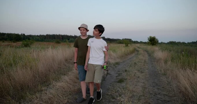 Two boys walk hiking on nature. Teenagers spending time together. 4K 10-bit