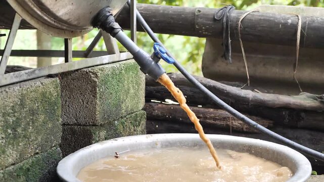 Contaminated dirty tap water flowing dark sediments 
Contaminated, murky, and polluted domestic water