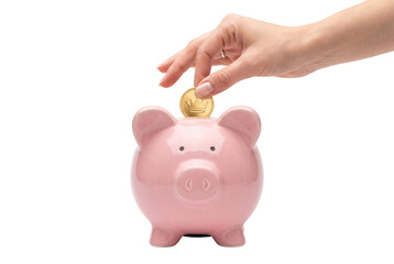 Fototapeta premium Hand inserting gold coin into pink piggy bank