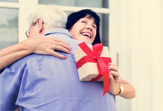 Wife hugging husband for the present