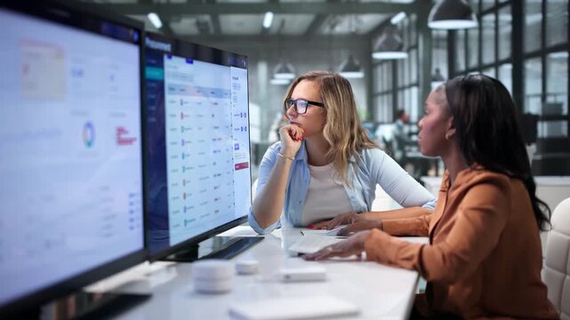 Procurement Manager And Assistant Discuss Supplier Contracts