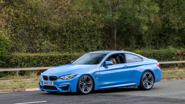 Milton Keynes; UK - Sept. 13th 2026:  2019 blue BMW M4 car driving on a British road