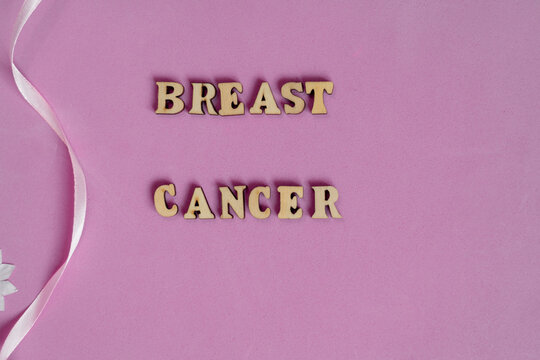 Breast cancer. Wooden letters and pink background. Copy space.