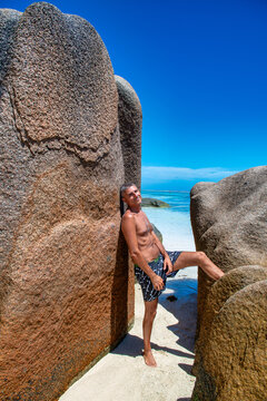 Man experiencing paradise beach atmosphere on La Digue