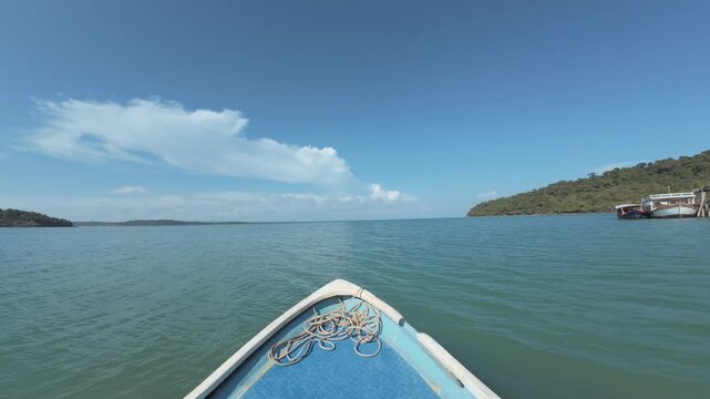 Calm shallow sea with pier and distant shoreline