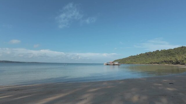 Calm ocean bay with long wooden pier