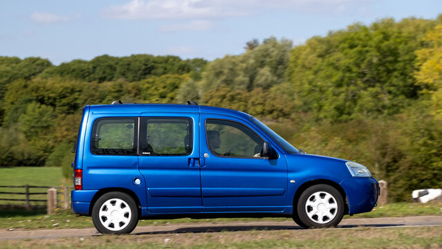 Milton Keynes; UK - Sept. 20th 2026: 2006 blue Citroen Berlingo diesel engine car driving on a British road