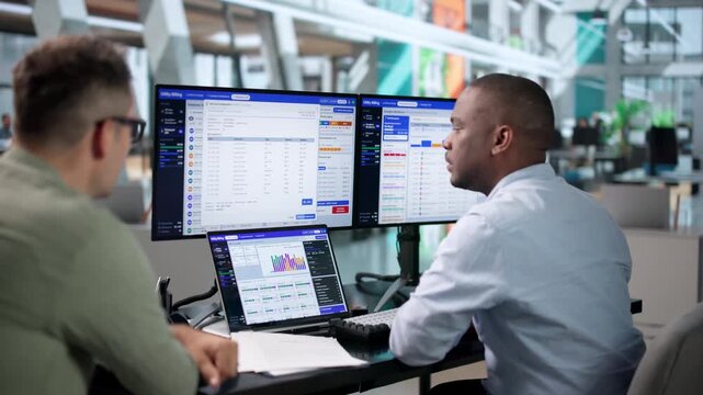 Utility Manager Reviewing Customer Billing Data During Outage Restoration