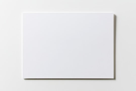 Studio shot of an unmarked white notecard with soft shadows and pristine simplicity