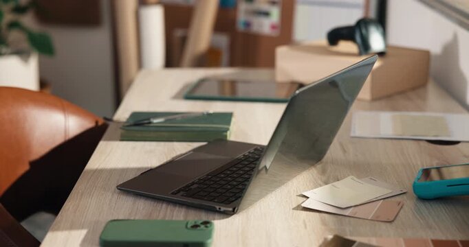 Empty, office and laptop at small business for ecommerce, logistics and color palette for fashion. Pc, sample and selection in workplace with pc, clothes collection and online retail for distribution