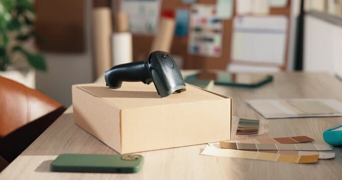 Office, box and scanner at startup for ecommerce, logistics and color palette for fashion launch. Barcode, parcel or sample in workplace with pc, clothes collection and online retail for distribution