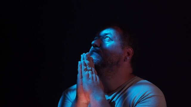 a man praying and looking up