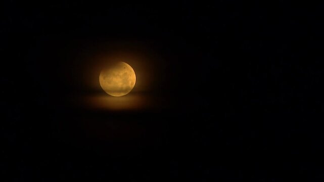 the beauty of the golden full moon shining brightly in the middle of the dark night sky