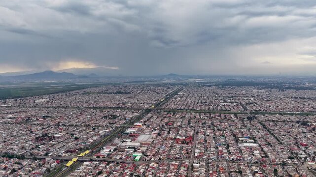 Drone hyperlapse of Ecatepec beneath dramatic storm clouds