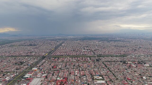 Aerial view of Ecatepec beneath dramatic storm clouds