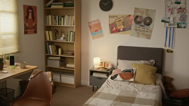 Empty teenager bedroom captured showing study area and bed. Footage ideal for student housing marketing, youth lifestyle content, or educational accommodation promotions