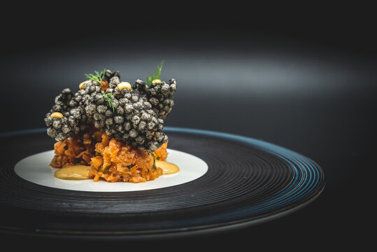 Gourmet seafood appetizer served on a black plate