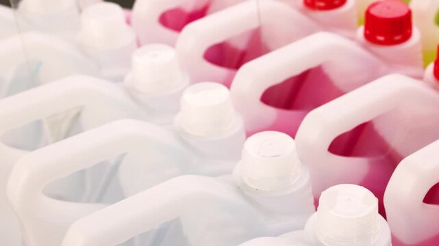 Rows of windshield washer fluid bottles in pink and yellow