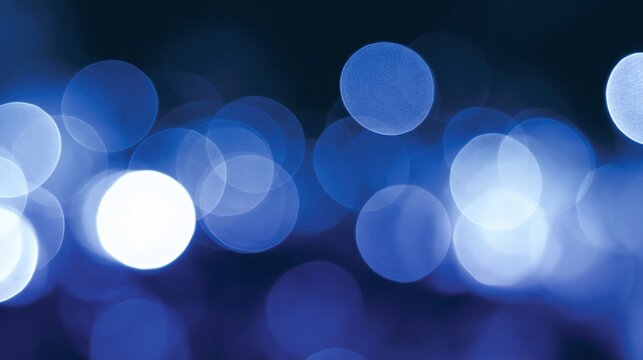 Blue bokeh light orbs glow softly on dark