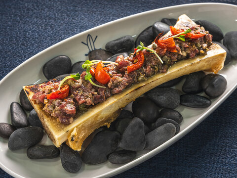 Grilled bone marrow with herbs and roasted tomatoes