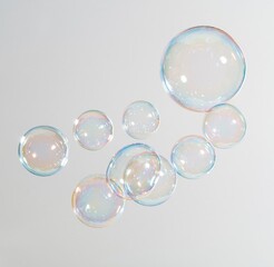 Obraz premium Colorful soap bubbles floating against a white background