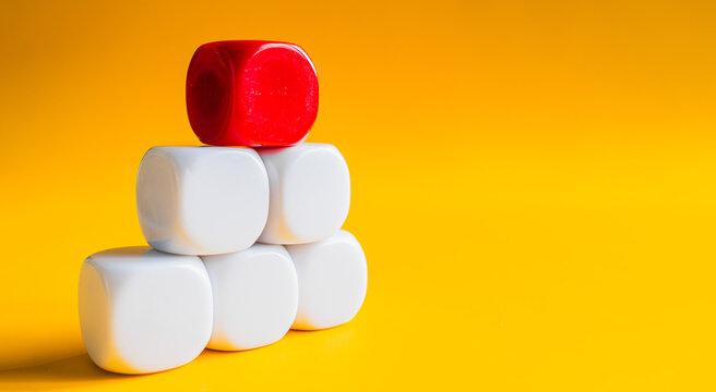 White and red blocks stacked in pyramid shape on yellow banner background with space for text
