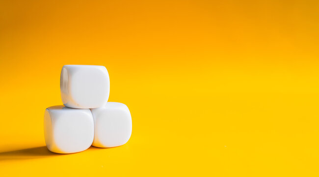 Three white blocks stacked in pyramid shape on yellow banner background with space for text