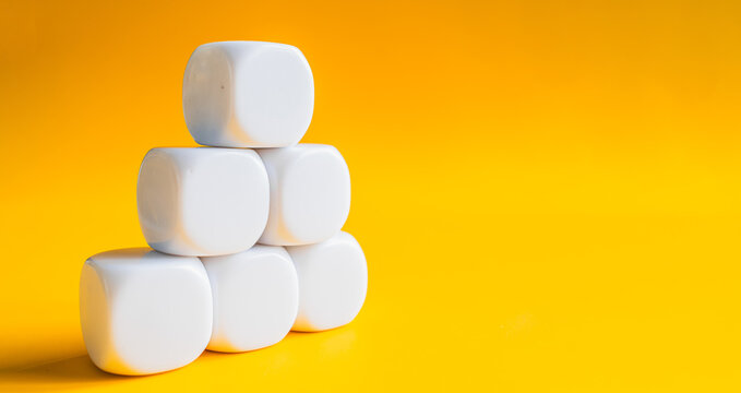 White blocks stacked in pyramid shape on yellow banner background with space for text