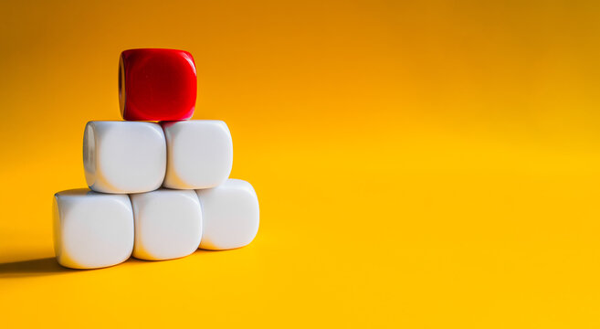 White and red blocks stacked in pyramid shape on yellow banner background
