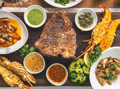 Grilled steak and seafood platter with dipping sauces