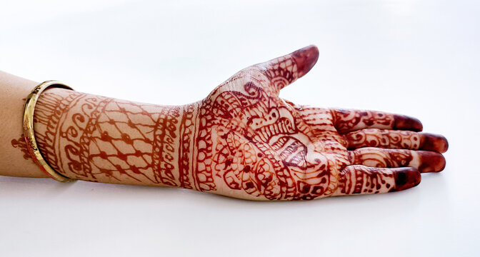Beautiful Indian female hands with henna tattoo isolated on whit