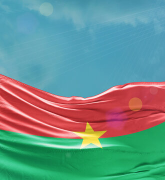 Burkina Faso flag banner waving in the sky.