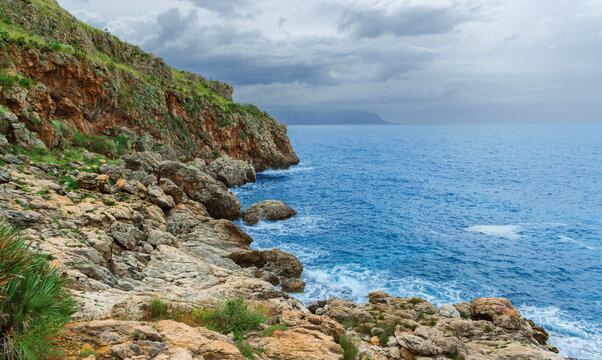 picturesque rocks and cliffs coast line along sea scape water blue surface panoramic background landscape in cloudy weather