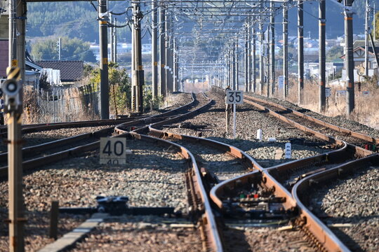 分岐する線路と架線柱が続く日本の鉄道風景