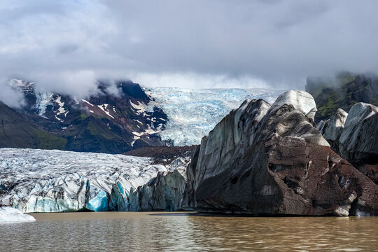 Layered and dirty edge of glacier tongue, close up. Svinafellsjokull or Outlet glacier in the south-east of the island and part of Vatnaj&ouml;kull - "Glacier of Lakes", called as Vatna Glacier. Iceland.