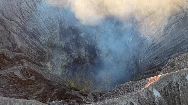 Volcanic Bromo Crater emits thick, swirling smoke. Rugged terrain surrounds the opening
