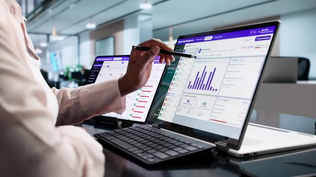 Association Manager Reviews Membership Data On Laptop