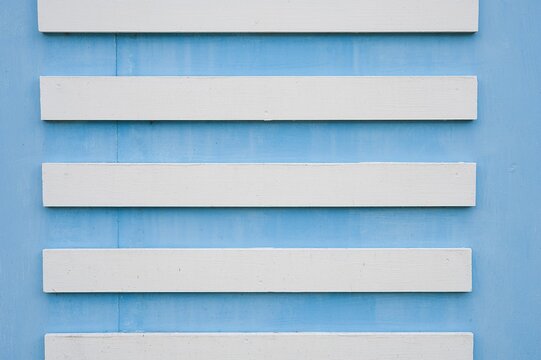 Light blue plastic horizontal blinds texture background close-up