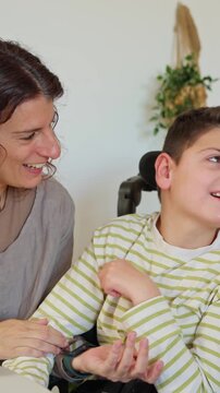 Mother tenderly caring for son with cerebral palsy