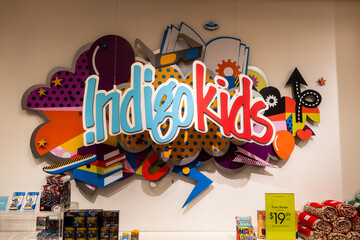 Naklejka premium Toronto, Canada - June 18, 2026: Indigo Kids section with colorful sign and books on display